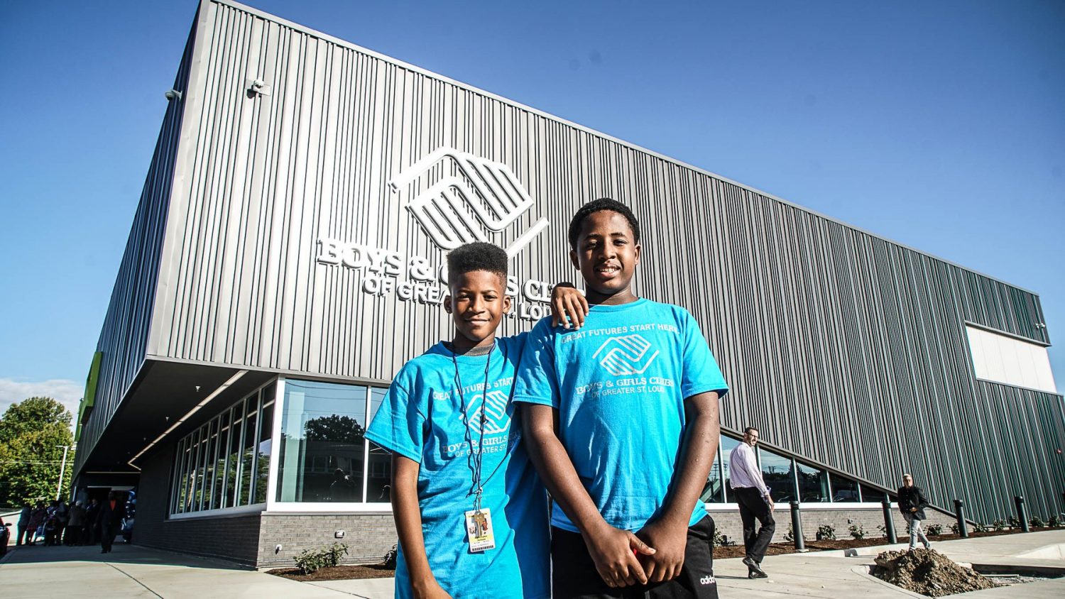 two boys standing in front of new building